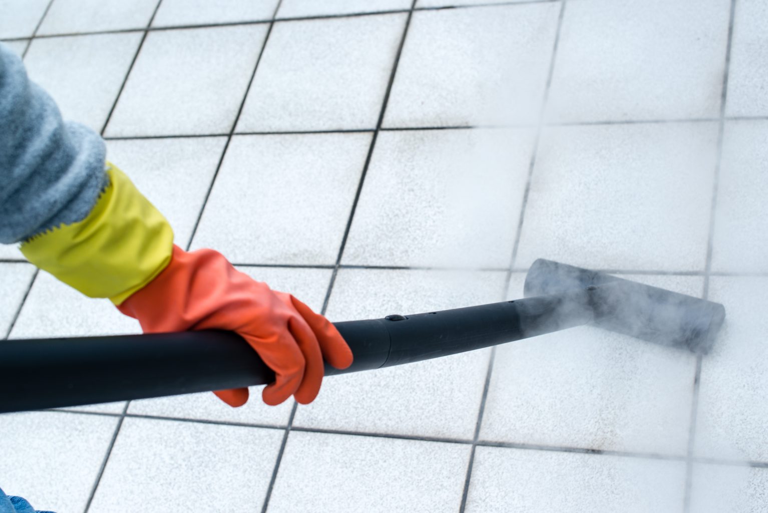 Woman using steam cleaner Residential Carpet Cleaning Service
