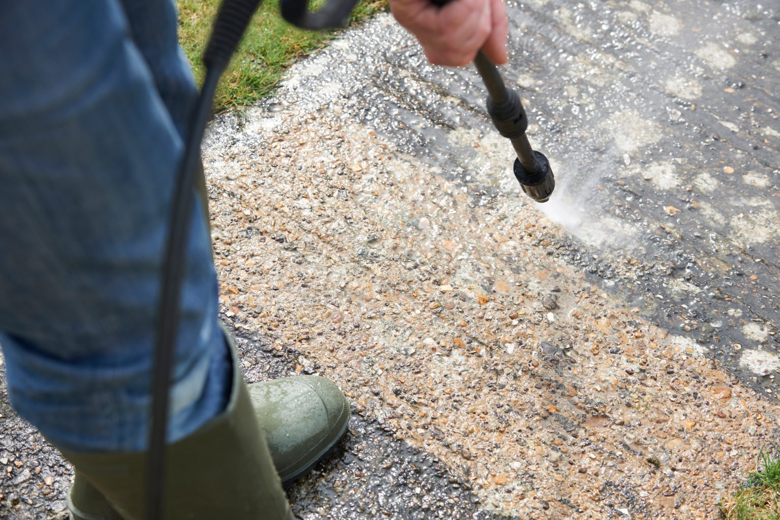 Man Washing Concrete Path With Pressure Washer Professional Carpet Cleaning Services for Homes